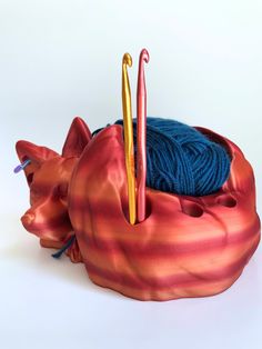 there is a yarn ball and two crochet hooks