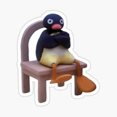 a penguin sitting on a chair with its arms crossed