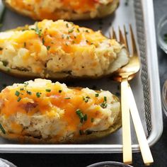 baked potatoes with cheese and herbs on a tray