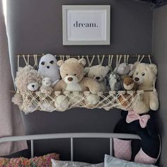 there are many stuffed animals on the shelf above the bed in this child's room