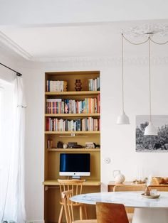 a living room filled with furniture and bookshelves