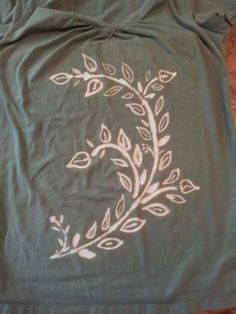 a t - shirt with an embroidered design on it