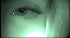 a woman's eye is glowing in the dark