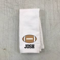 a white towel with an image of a football and the word, joseph on it