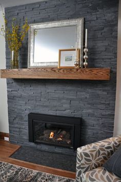 a living room with a fire place and a mirror on the wall above it's mantle