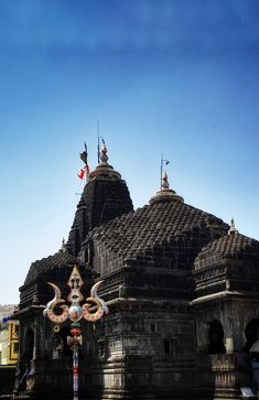 an ornately decorated building with flags flying in the background