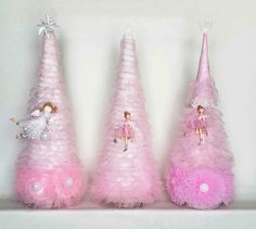 three pink christmas trees with angels on them