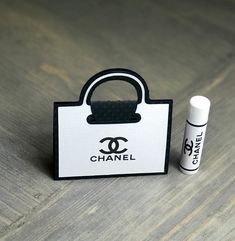 a small bag with an eye on it next to a lip bale