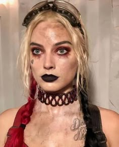 a woman with long hair and black lipstick on her face is wearing a choker