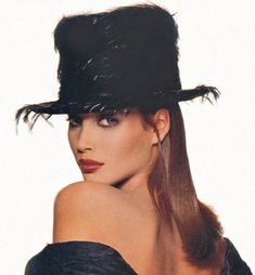 a woman wearing a black hat with long hair