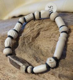 Bone bead stretchy bracelet. Bones are hand carved water buffalo beads. Roll on to your wrist. Bracelet is 6.5 inches. Fits comfortably on my 7.5 inch wrist. Bone Hand Bracelet, Bone Beads Jewelry, Adjustable Bone-colored Bracelet, Bone Cuff, Adjustable Handmade Skull Bracelets, Bone Bracelet, Bones Bracelet, Wrist Bracelet, Water Buffalo