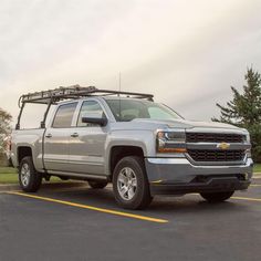 a silver truck parked in a parking lot