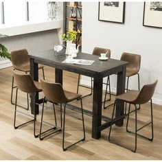 a dining room table with four chairs around it