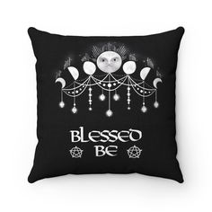 a black pillow with an image of the moon and crescents on it that says, blessing