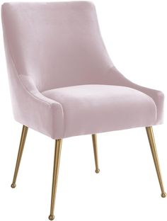 a pink velvet chair with gold legs