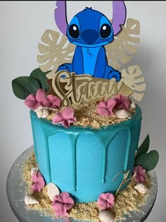 there is a blue cake with an elephant on top