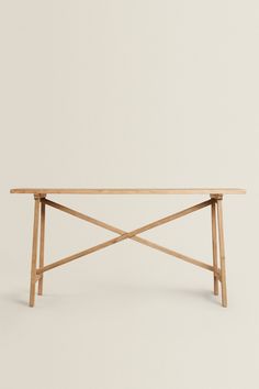 a wooden table sitting on top of a white floor