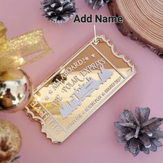 a christmas ornament is hanging on a pink background with other ornaments and decorations