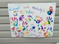 a sign with hand prints on it that says michael and melody's 5th birthday