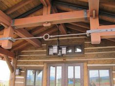 the inside of a wooden building with glass doors