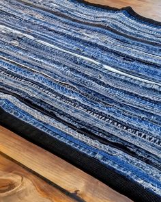 a blue and black quilt on top of a wooden table