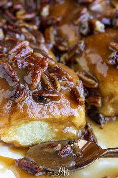 pecans and cinnamon rolls are covered in caramel glaze