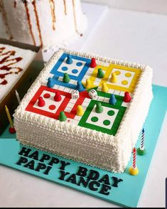 a birthday cake decorated with dominos and candles