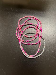 Shades of pink and clear glass seed beads in a random design on stretchy elastic string.  Unstretched, these bracelets measure approximately 6.75 inches.  Stretching adds several inches for ease of putting them on and taking them off. Pink Seed Bead Bracelet Ideas, Pink And Purple Beaded Bracelet, Glass Seed Bead Bracelet Ideas, Seed Bead Bracelet Ideas, Bead Bracelet Stack, Bead Bracelet Patterns, Seed Bead Bracelet Patterns, Pink Beaded Bracelets, Bead Bracelet Ideas