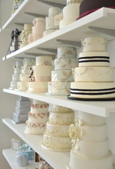 many different types of wedding cakes on shelves