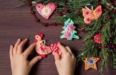 someone is decorating their christmas ornaments with crochet and bead yarns