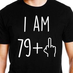 a man wearing a black t - shirt that says i am 59 plus with white writing on it