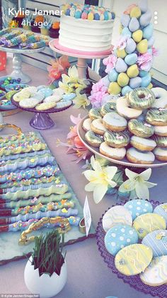 an assortment of desserts and pastries on display at a party or gathering table