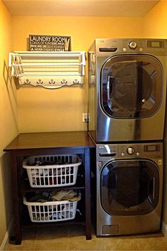 a washer and dryer sitting next to each other in a small laundry room