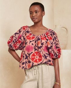 A quick-change artist, this bold top has an adjustable neckline so you can wear it as a scoop during the day and off the shoulder at night. It's woven in a blend of cotton and silk, has an oversized print, and features puff sleeves and a slightly shortened length for flattering proportions.  From Velvet by Graham & Spencer. Elastic neckline; wear as a scoop neck or off the shoulder. Elbow-length raglan puff sleeves with elastic cuffs. Multicolor Top With Gathered Balloon Sleeves, Multicolor Tops With Gathered Balloon Sleeves, Multicolor Balloon Sleeve Top With Gathered Sleeves, Multicolor Tops With Balloon Gathered Sleeves, Multicolor Puff Sleeve Top With Gathered Sleeves, Bohemian Summer Top With Puff Sleeves, Bohemian Puff Sleeve Summer Tops, Summer Bohemian Top With Puff Sleeves, Summer Peasant Top With Balloon Sleeves And Relaxed Fit