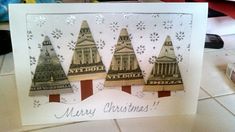 a christmas card with three trees on it