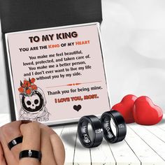 two wedding rings are being held up to a card with the words to my king on it