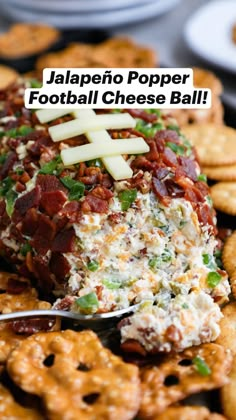 a football shaped appetizer on a platter with crackers