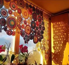 the sun shines through an open window with doily hanging from it's side