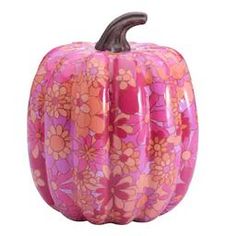 a pink and orange pumpkin with flowers on it