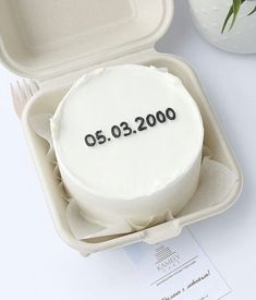 a white cake in a box with the date 2000 - 2009 on it's side