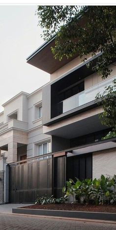 an apartment building with several balconies on the second floor