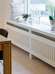 an image of a window sill in the middle of a room with white furniture