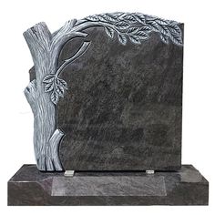 a black and white photo of a tree on a granite block with two silver leaves