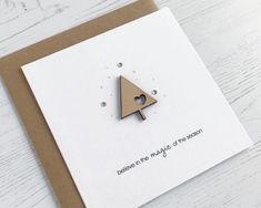 a card with a wooden triangle on it