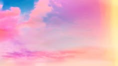 an airplane flying in the sky with pink and blue clouds