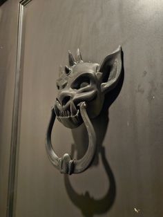 a metal door handle with a cat's head on it