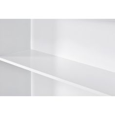 a white shelf sitting in the corner of a room