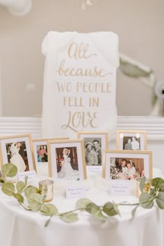 a table topped with pictures and greenery next to a white sign that says life because two people fell in love