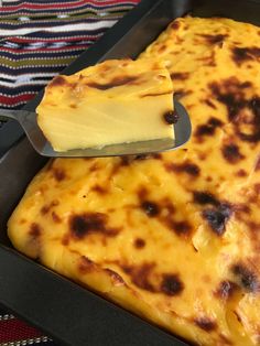 a spatula being used to scoop cheese into a pan