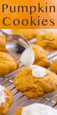 pumpkin cookies with white icing being drizzled onto them on a cooling rack